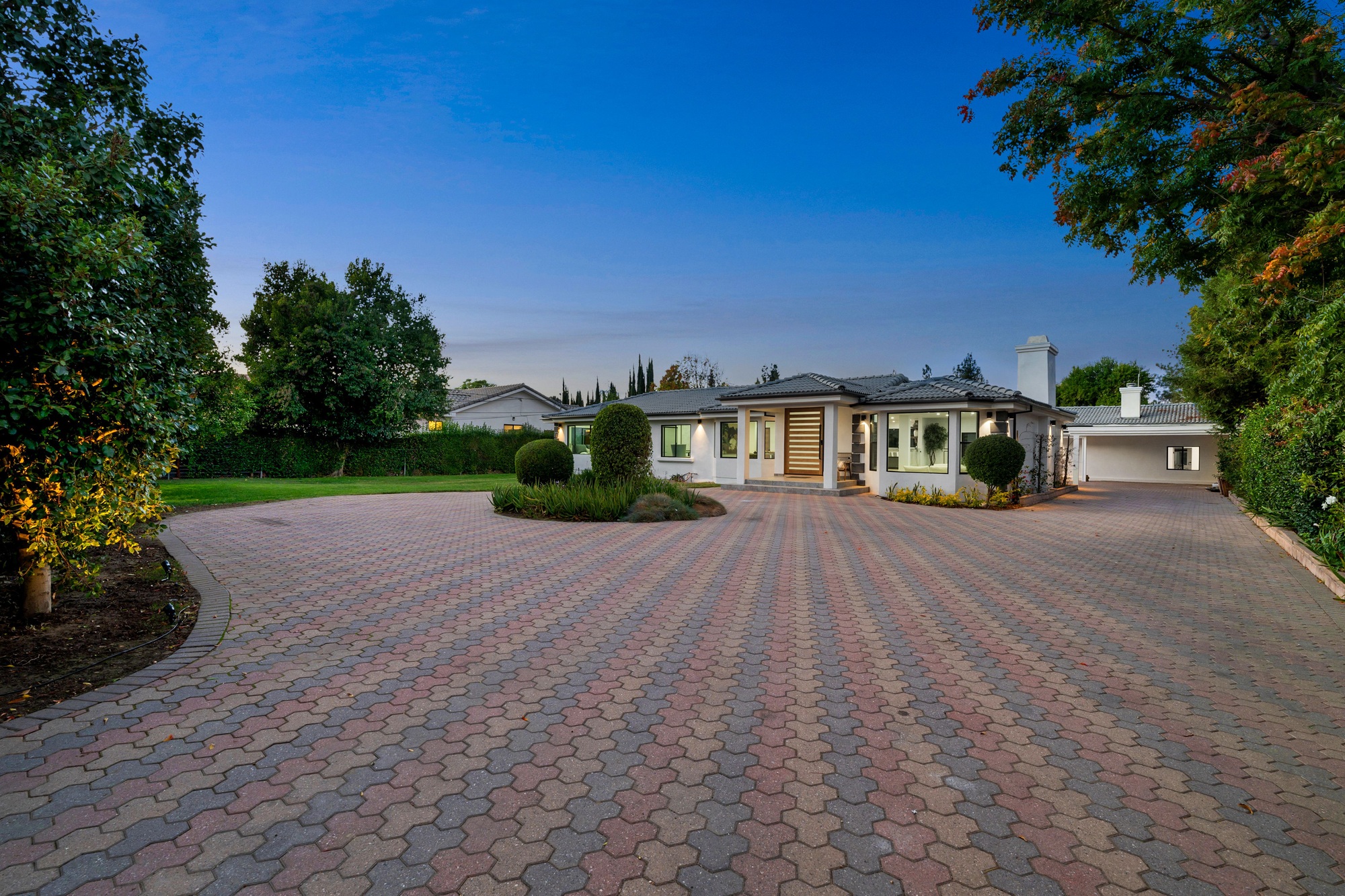 Elegant suburban home with a paved driveway.