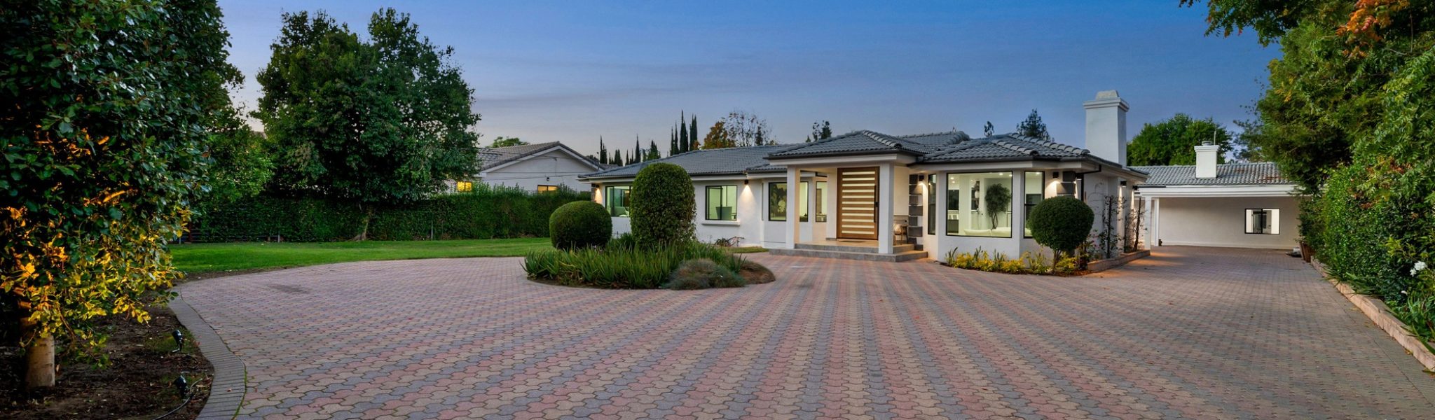 Elegant suburban home with a paved driveway.